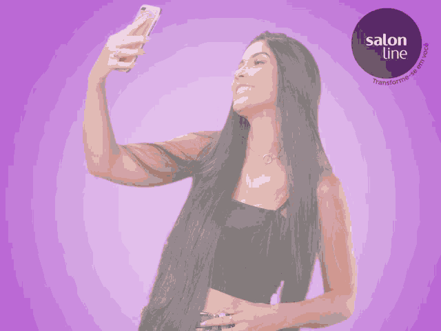 a woman with long hair is taking a selfie with a salon line logo behind her