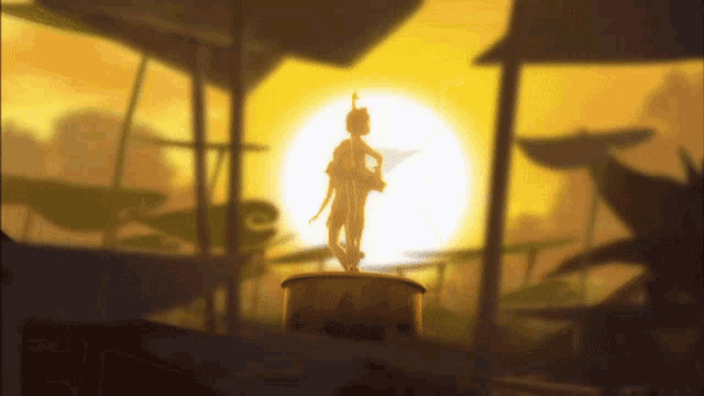 a statue of tinkerbell stands in front of a sun