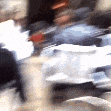 a blurry photo of a group of people sitting at a table