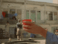 a blurry picture of a person holding a red cup with the number 1 on it
