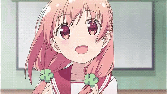 a girl with pink hair is holding her hair in a ponytail .