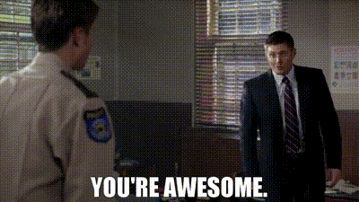a man in a suit and tie is standing next to another man in a police uniform and says `` you 're awesome '' .