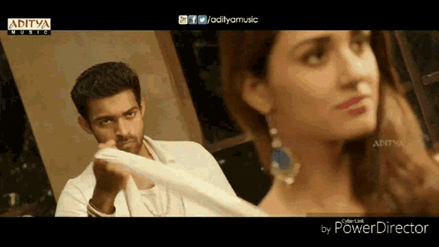 an ad for aditya music shows a man and a woman standing next to each other