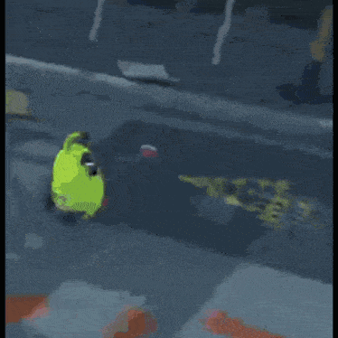 a pink cartoon character with a green hat is walking down the street