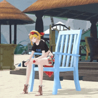 a girl sits on a blue chair on the beach wearing a black shirt that says ' la ' on it