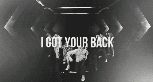 a group of people are dancing in a dark room with the words i got your back