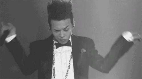 a black and white photo of a man in a tuxedo and bow tie .