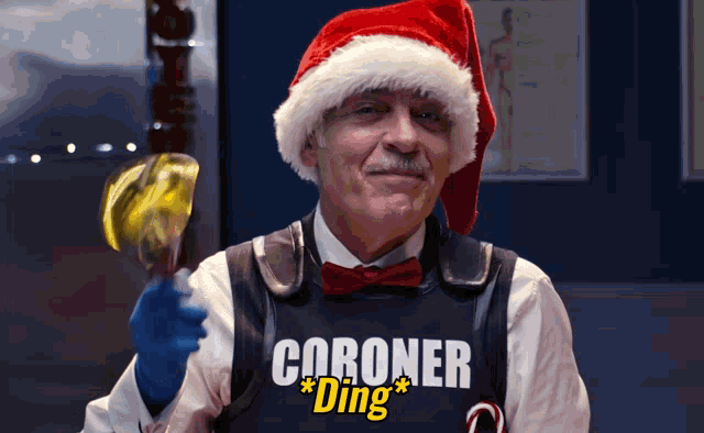 a man wearing a santa hat and vest that says coroner ding