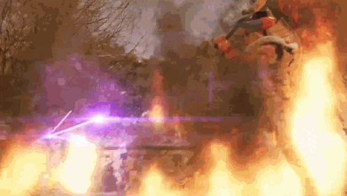 a person is flying through the air in front of a fire