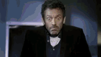 a man in a tuxedo is making a funny face .