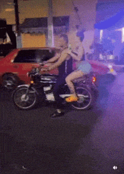 a man and a woman are riding a motorcycle