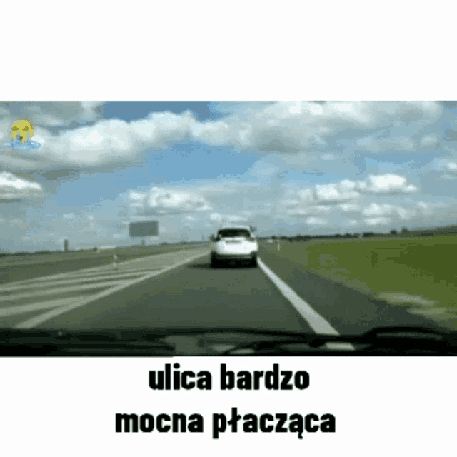 a car is driving down a highway with the words ulica bardzo mocna ptaczaca written below it