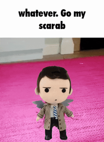 a stuffed doll is standing on a pink rug with the words whatever go my scarab above it