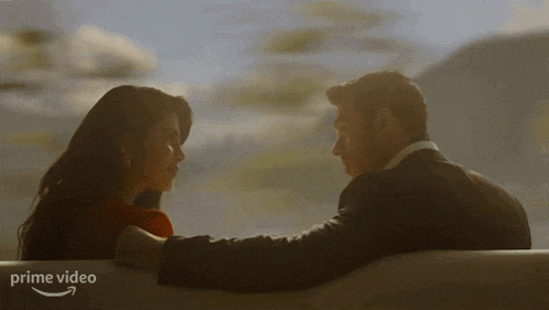 a man and woman are looking into each other 's eyes with a prime video logo in the background