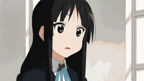 a girl with long black hair and a blue bow tie looks at the camera