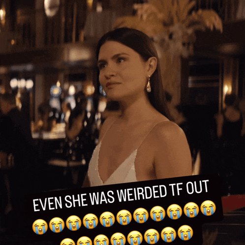 a woman in a white dress is behind a sign that says " even she was weird tf out "
