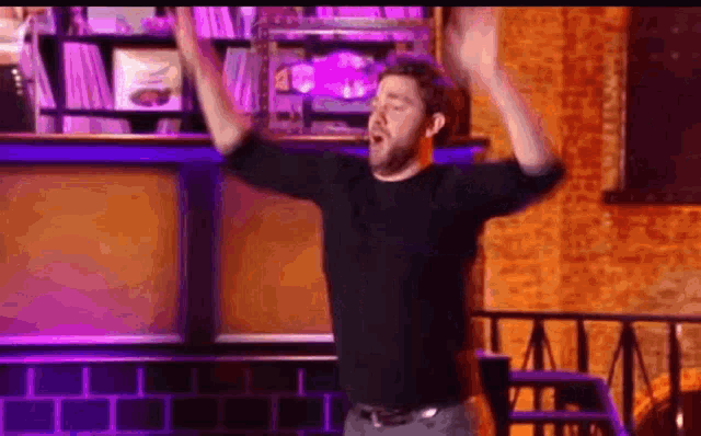 a man is standing with his arms in the air .