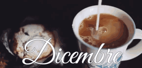 a cup of coffee with a spoon in it and the word dicembre on the bottom