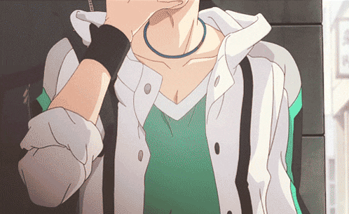 a man wearing a white jacket and a green shirt has a black wristband around his wrist