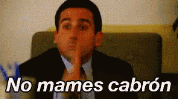 a man in a suit and tie is holding his finger to his lips and says no mames cabron ..