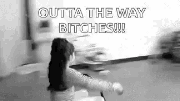 a black and white photo of a little girl saying outta the way bitches !