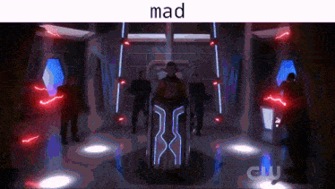 a group of people are standing in a room with the word mad on the top