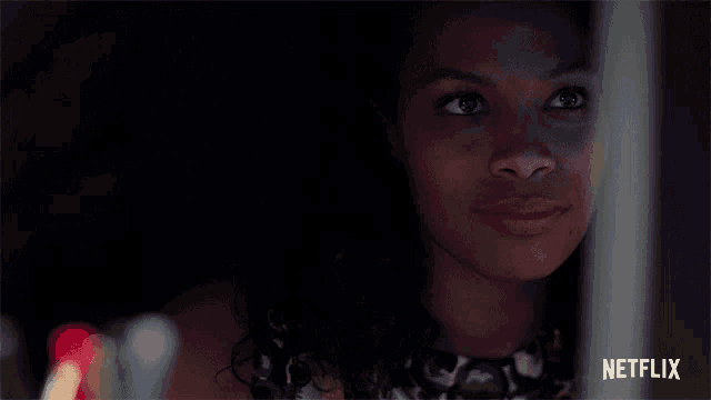 a close up of a woman 's face with a netflix logo in the background