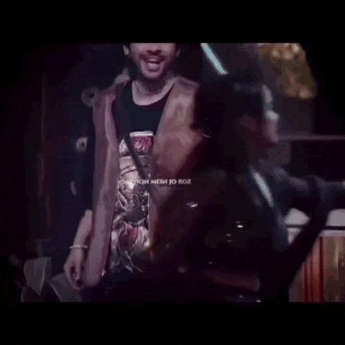 a group of people are dancing in a dark room with the words chaloo chale written on the bottom