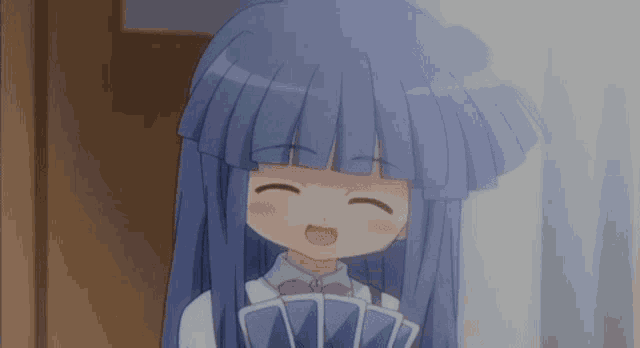 a girl with blue hair is smiling while holding a fan of cards .