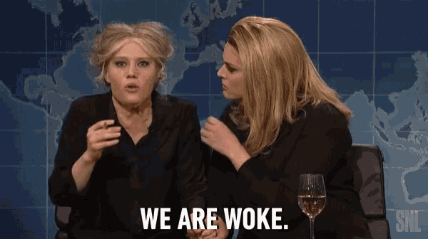 two women sitting next to each other with the words we are woke on the screen