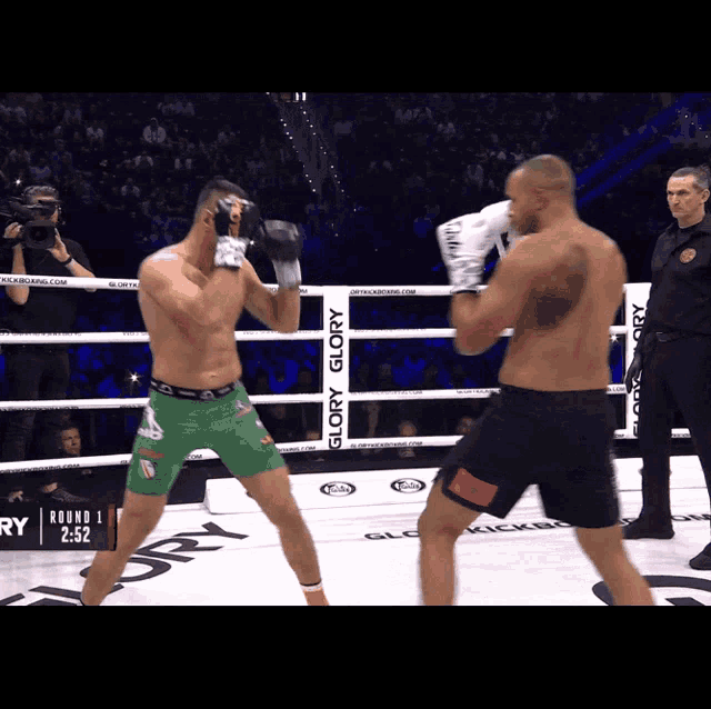 two boxers are fighting in a ring that says glory glory on it