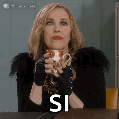 a woman holding a cup with the word si written on it