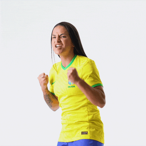 a woman wearing a yellow jersey with the word brasil on it