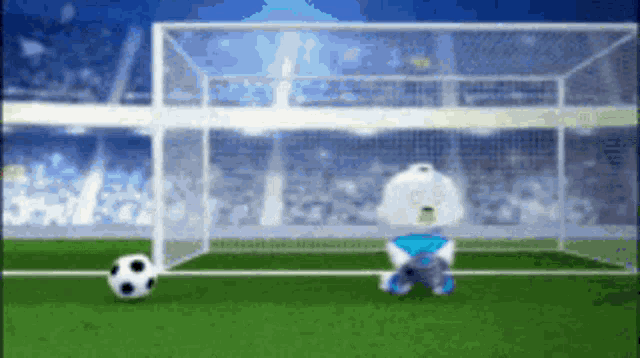 a soccer goalie is sitting on the field watching a soccer ball
