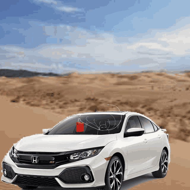 a white honda car is parked in the desert