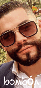 a man with a beard is wearing sunglasses and the word bombon is on the bottom right