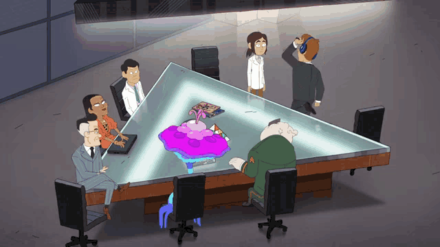 a group of people are sitting around a table with a triangle in the middle