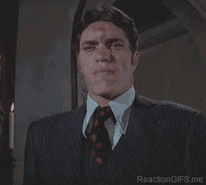 a man in a suit and tie with missing teeth .