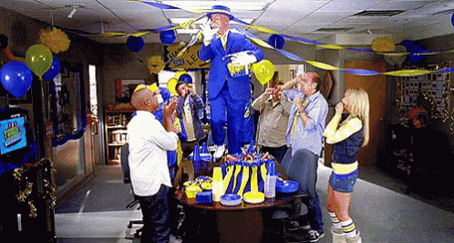a group of people are gathered around a table with a sign that says fox sports