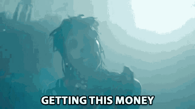 a man with dreadlocks is singing into a microphone with the words getting this money above him