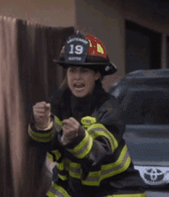 a fireman wearing a helmet that says 19 on it