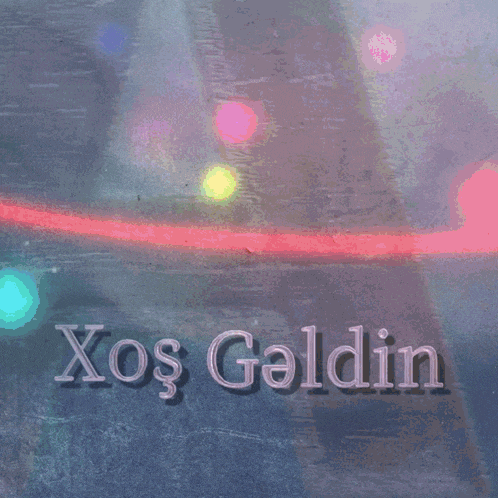 a sign that says xos geldin on it with a bridge in the background