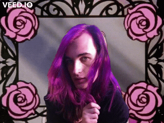 a woman with purple hair stands in front of a frame with pink roses