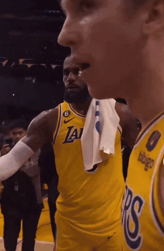 a basketball player with a towel around his neck and the number 6 on his jersey