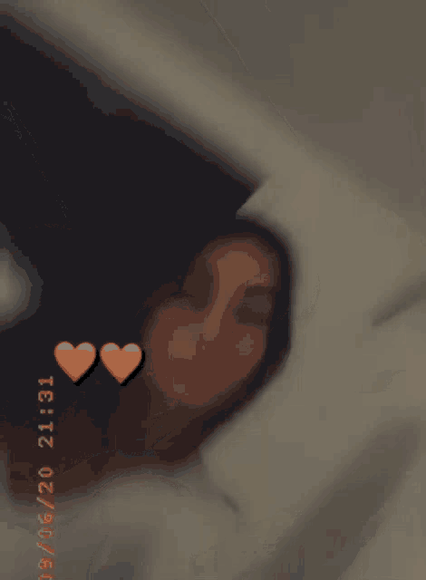 a blurry photo of a woman with hearts on her face