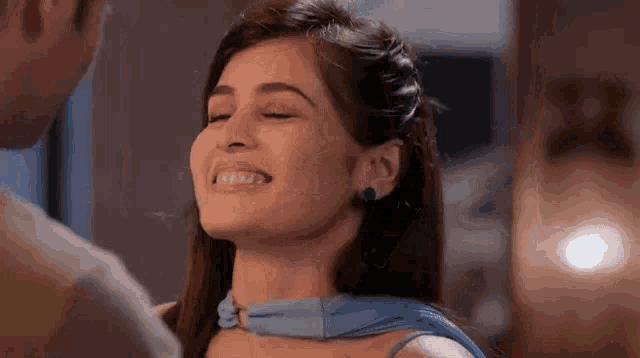 a woman is smiling and looking at a man .