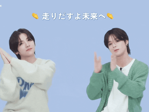 two young men are standing next to each other in front of a blue background with chinese characters