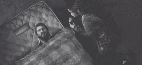 a black and white photo of a man and a woman laying on a mattress .