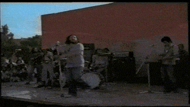 a group of people playing instruments on a stage with the word plutos above them