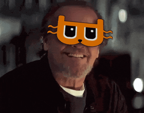 a man wearing a mask with the letter b on it smiles